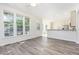 Open living area with abundant sunlight, wood floors, and seamless access to the kitchen, perfect for entertaining at 1613 Patterson Grove Rd, Apex, NC 27502