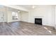 Bright living room with large windows, hardwood floors, and a modern fireplace at 1613 Patterson Grove Rd, Apex, NC 27502