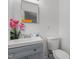 Bathroom with gray vanity and an above mount sink, and decorative mirror at 1832 Blandwood Dr, Rocky Mount, NC 27801