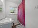 Bathroom with a combination shower-tub, vanity and wood look flooring plus a window at 1832 Blandwood Dr, Rocky Mount, NC 27801