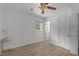 Bedroom with wood look floors, white walls, and a ceiling fan, plus a view of the hall at 1832 Blandwood Dr, Rocky Mount, NC 27801