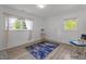 Bright bedroom featuring hardwood floors, natural light, and modern decor for a cozy and inviting space at 1832 Blandwood Dr, Rocky Mount, NC 27801