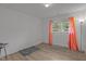 Neutral bedroom featuring hardwood floors, a window with curtains, and ample space at 1832 Blandwood Dr, Rocky Mount, NC 27801