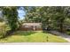 Full front view of a traditional brick ranch style home, with mature landscaping at 1832 Blandwood Dr, Rocky Mount, NC 27801