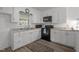 Well-lit kitchen with white cabinetry, modern appliances, and a cozy rug at 1832 Blandwood Dr, Rocky Mount, NC 27801