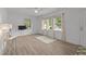 Bright living room featuring hardwood floors, large windows and neutral wall paint at 1832 Blandwood Dr, Rocky Mount, NC 27801
