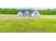 Picturesque aerial view of a modern farmhouse surrounded by verdant greenery and lush landscaping at 193 Jim S Rd, Cameron, NC 28326