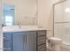 Updated bathroom featuring modern gray vanity, quartz countertop, and glass-enclosed shower at 193 Jim S Rd, Cameron, NC 28326