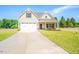New home with a large driveway, covered front porch, and a two-car garage at 193 Jim S Rd, Cameron, NC 28326