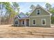 Quaint two-story home with a covered front porch and a well-maintained lawn in a neighborhood setting at 193 Jim S Rd, Cameron, NC 28326