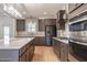 Modern kitchen features dark wood cabinets, a large island with marble countertops, and stainless steel appliances at 193 Jim S Rd, Cameron, NC 28326