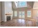Bright living room with fireplace, wood floors, vaulted ceiling, and access to backyard at 193 Jim S Rd, Cameron, NC 28326