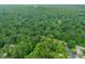 Aerial neighborhood view surrounded by mature trees, green grass, roads, and multiple buildings at 20 Timberlyne Rd, Chapel Hill, NC 27514