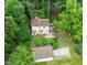 An aerial view of a charming home with a deck, lush greenery, and a detached garage at 20 Timberlyne Rd, Chapel Hill, NC 27514