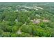 Aerial view of residential neighborhood with mature trees, lush greenery, and winding roads at 20 Timberlyne Rd, Chapel Hill, NC 27514