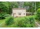 Beautiful home's backyard with green lawn, tall trees and surrounding greenery at 20 Timberlyne Rd, Chapel Hill, NC 27514
