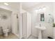 Bright bathroom includes a pedestal sink, walk-in shower, and linen storage at 20 Timberlyne Rd, Chapel Hill, NC 27514
