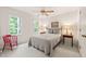Comfortable bedroom featuring a ceiling fan, carpeted floor, and natural light at 20 Timberlyne Rd, Chapel Hill, NC 27514