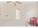 Bright bedroom with a neutral palette, double closets, and a quirky red chair at 20 Timberlyne Rd, Chapel Hill, NC 27514