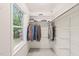 Walk-in closet with custom shelving and abundant storage space, plus a bright window at 20 Timberlyne Rd, Chapel Hill, NC 27514
