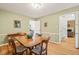 Bright dining room showcases wood floors, ample windows, and seamless access to other living spaces at 20 Timberlyne Rd, Chapel Hill, NC 27514