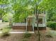 Charming home with brick foundation, white porch railing, and mature trees at 20 Timberlyne Rd, Chapel Hill, NC 27514