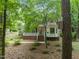 Charming home with brick foundation, white porch railing, and mature trees at 20 Timberlyne Rd, Chapel Hill, NC 27514