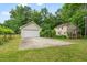 A home's exterior with a detached garage and spacious concrete driveway and green yard at 20 Timberlyne Rd, Chapel Hill, NC 27514