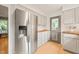 Well-lit kitchen features stainless steel refrigerator and white cabinets with wood countertops at 20 Timberlyne Rd, Chapel Hill, NC 27514