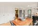 Eat-in kitchen featuring stainless steel appliances, light colored cabinets, and hardwood table at 20 Timberlyne Rd, Chapel Hill, NC 27514