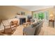 Cozy living room with a brick fireplace, hardwood floors, and a bay window at 20 Timberlyne Rd, Chapel Hill, NC 27514