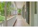 Side porch with white railing and view of lawn and trees at 20 Timberlyne Rd, Chapel Hill, NC 27514