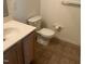 Standard bathroom featuring a tiled floor, toilet, sink and hardware at 2000 University Woods Rd # 203, Raleigh, NC 27603