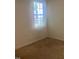 Modest bedroom with neutral carpet, window with blinds and electrical outlets at 2000 University Woods Rd # 203, Raleigh, NC 27603