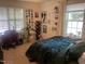 Comfortable bedroom featuring a work station area, a large bed, and a window at 2000 University Woods Rd # 203, Raleigh, NC 27603