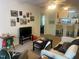 Inviting living room featuring neutral carpeting, ceiling fan, and access to kitchen and bedroom at 2000 University Woods Rd # 203, Raleigh, NC 27603