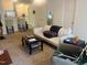Comfortable living room with neutral carpet, sofa, coffee table, and adjacent dining area at 2000 University Woods Rd # 203, Raleigh, NC 27603