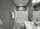 Bathroom featuring a shower-tub, single vanity, and herringbone floors at 202 S Pearl St, Princeton, NC 27569