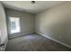 This bedroom features neutral walls, carpet flooring and a window bringing in natural light at 202 S Pearl St, Princeton, NC 27569