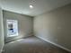 Bedroom featuring a window, carpet, and off-white walls at 202 S Pearl St, Princeton, NC 27569