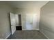 This bedroom features neutral walls, carpet flooring and two doors at 202 S Pearl St, Princeton, NC 27569