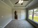Bedroom featuring carpet, a ceiling fan, window view, and access to an ensuite bathroom at 202 S Pearl St, Princeton, NC 27569