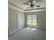 Serene bedroom featuring soft carpet, large windows, and a tray ceiling at 202 S Pearl St, Princeton, NC 27569