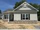 Charming single-Gathering home featuring stone accents, dark shutters, and an inviting covered entrance at 202 S Pearl St, Princeton, NC 27569