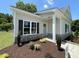 Attractive single story home with beautiful landscaping, stone accents, and a covered porch at 202 S Pearl St, Princeton, NC 27569