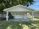 A well-maintained detached garage with a white door and ample parking space at 202 S Pearl St, Princeton, NC 27569