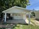 New garage features white siding and a concrete driveway, perfect for parking and storage at 202 S Pearl St, Princeton, NC 27569