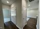 Hallway features a seamless blend of hardwood and carpeted flooring, creating a cozy and elegant transition between rooms at 202 S Pearl St, Princeton, NC 27569