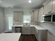 Modern kitchen featuring stainless steel appliances, abundant cabinet space, and contemporary fixtures at 202 S Pearl St, Princeton, NC 27569