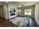 Spacious living room with a modern fireplace, ceiling fan, hardwood floors, and plenty of natural light at 202 S Pearl St, Princeton, NC 27569